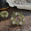 Detailed view of vintage lily of the valley enamel brooch with green leaves and pearls - Lily of the Valley Wreath