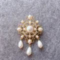 Close-up of vintage gold-tone brooch with elegant pearls and sparkling crystals - Baroque Hollow Drop Pearl Style (B3) / Gold