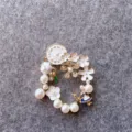 Detailed macro shot of vintage Alice in Wonderland theme floral pearl wreath brooch pin - Alice in Wonderland Theme (B2) / Gold