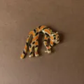 Close-up of retro leopard brooch with orange and black enamel on gold metal finish. - Enamel Spotted Leopard Style (Style 6)