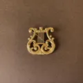 Detailed macro view of vintage baroque gold harp brooch with ornate filigree scroll design - Harp Style (Style 1)