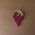 Close-up detail of a vintage Baroque style grape brooch with golden leaf and red beads - Grape Cluster Style (Style 4)