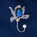 Elegant flower brooch with large blue crystal, colorful rhinestones and pearl accent. - Deep Blue Crystal Flower