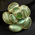Elegant vintage flower brooch pin with green cat eye stones and a golden finish - Light Green Cat Eye Flower