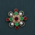 Detail macro view of a vintage Baroque brooch with red and green stones and pearls - Style 15