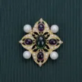 Macro detail of Baroque style vintage brooch with green and purple cabochon stones - Style 16