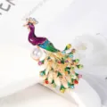 Elegant peacock brooch pin with vibrant multi-colored rhinestones and a large pearl detail. - Enamel Pearl Style (16)