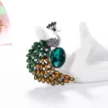 Elegant peacock brooch featuring a large green gemstone and colorful enamel feathers - Vintage Gold Green Stone Style (17)
