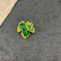 Elegant vintage green and yellow enamel leaf brooch with artistic gold vine detailing - Enamel Leaf Style