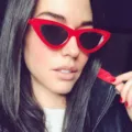 Fashionable retro cat eye sunglasses featuring a bold red frame and dark lenses - Red Frame