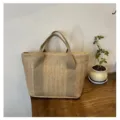 Elegante bolso de mano de paja tejida en color beige natural para vacaciones de verano. - Dorado