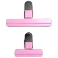Detailed macro view of pink plastic food sealing clips in long and short sizes for kitchen use - Pink