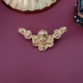 Macro detail of a vintage cherub relief brooch featuring an elegant matte gold finish - Angel Relief Style / Matte Gold