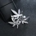 Close-up of a vintage silver maple leaf brooch featuring three white pearl accents - Silver Maple Leaf Pearl Style / Silver