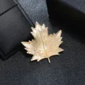 Detailed view of the intricate texture on a vintage matte gold maple leaf brooch. - Gold Brushed Maple Leaf Style