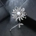 Close-up detail of an elegant silver flower brooch with white pearl and crystal leaves - Silver Long Stem Flower Pearl Style