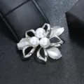 Detailed view of a vintage silver floral brooch featuring three elegant white pearls. - Silver Hollow Flower Leaf Three Pearl Style / Silver