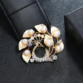 Detailed macro view of vintage matte gold peacock brooch adorned with pearls and crystals - Gold Peacock Pearl Rhinestone Style