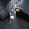 Detailed view of an elegant vintage metal floral leaf brooch with white pearl inlay - Gold And Silver Two-Tone Pearl Style