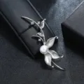 Detailed macro view of a vintage matte silver flower leaf brooch with a large white pearl center - Silver Flower Core Single Pearl Branch Style