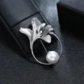 Detailed view of silver flower and leaf brooch with an elegant white pearl accent - Silver Streamlined Flower Leaf Large Pearl Style