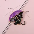 Cute black cat enamel brooch under a purple umbrella, size 4.3cm x 4.0cm detail view - Purple Umbrella Black Cat Brooch
