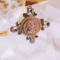 Vintage Baroque style cross brooch featuring grey crystals and an antique gold medallion badge - Antique Gold Smoky Gray Crystal Style / Style 1