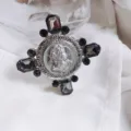 Vintage Baroque cross brooch featuring dark grey crystals and a central relief medallion - Antique Silver Smoky Gray Crystal Style / Style 2