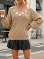 Detailed shot of a beige diamond knit sweater featuring 3D floral appliqués on V-neck. - S / Tops / Khaki
