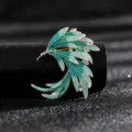 Close-up detail of a vintage wing brooch with green enamel and sparkling rhinestones - Style 2 (Gradient Cyan Blue Wing)