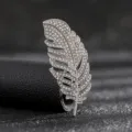 Detailed macro shot of an elegant silver feather brooch encrusted with pavé rhinestones. - Style 6 (Silver Full Rhinestone Feather)