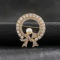 Close-up detail of a vintage elegant gold wreath brooch featuring crystal bow and pearl - Style 10 (Full Rhinestone Bow Wreath)