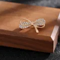 Elegant gold bow brooch with clear rhinestones for fashion accessories and bag decor. - Style 13 (Gold Full Rhinestone Bow)