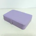 Minimalist purple leather jewelry storage box featuring a secure snap button closure - Purple