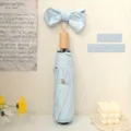 Elegante paraguas plegable azul claro con mango de madera y lazo grande para sol y lluvia - Manual 3 Pliegues Mango Imitación Madera Lazo / Azul cielo