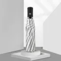 Compact folding sun umbrella with black and white stripes, stylish and portable daily rain gear. - 8-Bone Automatic Striped / Off White