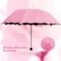 Rose pink folding umbrella with water-reactive flower pattern and scalloped edge - Pink