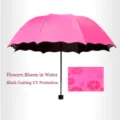Pink folding umbrella with blooming flower pattern when wet and UV protection coating. - Red
