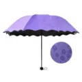Purple folding umbrella featuring a water-blooming floral design and scalloped edges - Purple