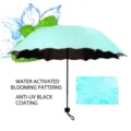 Mint blue scalloped folding umbrella with hidden flower pattern appearing when wet - Aqua Green