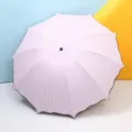 Pink and white striped sun umbrella with UV protection and stylish wavy black trim. - 10-Bone Striped / Pink