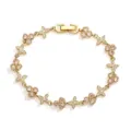 Detailed view of a gold clover and butterfly bracelet with sparkling inlaid stones - Gold White Rhinestone