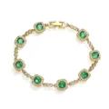 Close-up of gold-plated bracelet featuring green square halo cubic zirconia stones. - Gold Green Rhinestone