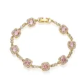 Detailed macro view of a sparkling pink cushion-cut stone bracelet with a halo setting - Gold Pink Zirconia