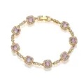 Close-up view of an elegant gold bracelet with square lavender gemstone charms and halos - Gold Purple Zirconia