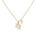 Close-up of a gold Virgo zodiac pendant necklace with a delicate white pearl detail. - Virgo / Gold