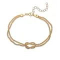 Macro detail view of a vintage gold-plated infinity knot snake bone chain bracelet - Stardust Infinity Knot / Gold
