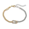Close-up detail of the intertwined two-tone love knot bracelet with mesh starburst chains - Stardust Infinity Knot / Gold and White Colorblock