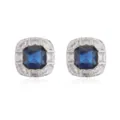 Macro view of luxurious square stud earrings with a blue gem and white diamond halo - Blue Zirconia / White Gold