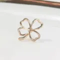 Detailed macro shot of an elegant rose gold four-leaf clover brooch pin with hollow design - Hollow Four-Leaf Clover Style (ae2321321) / Rose Gold